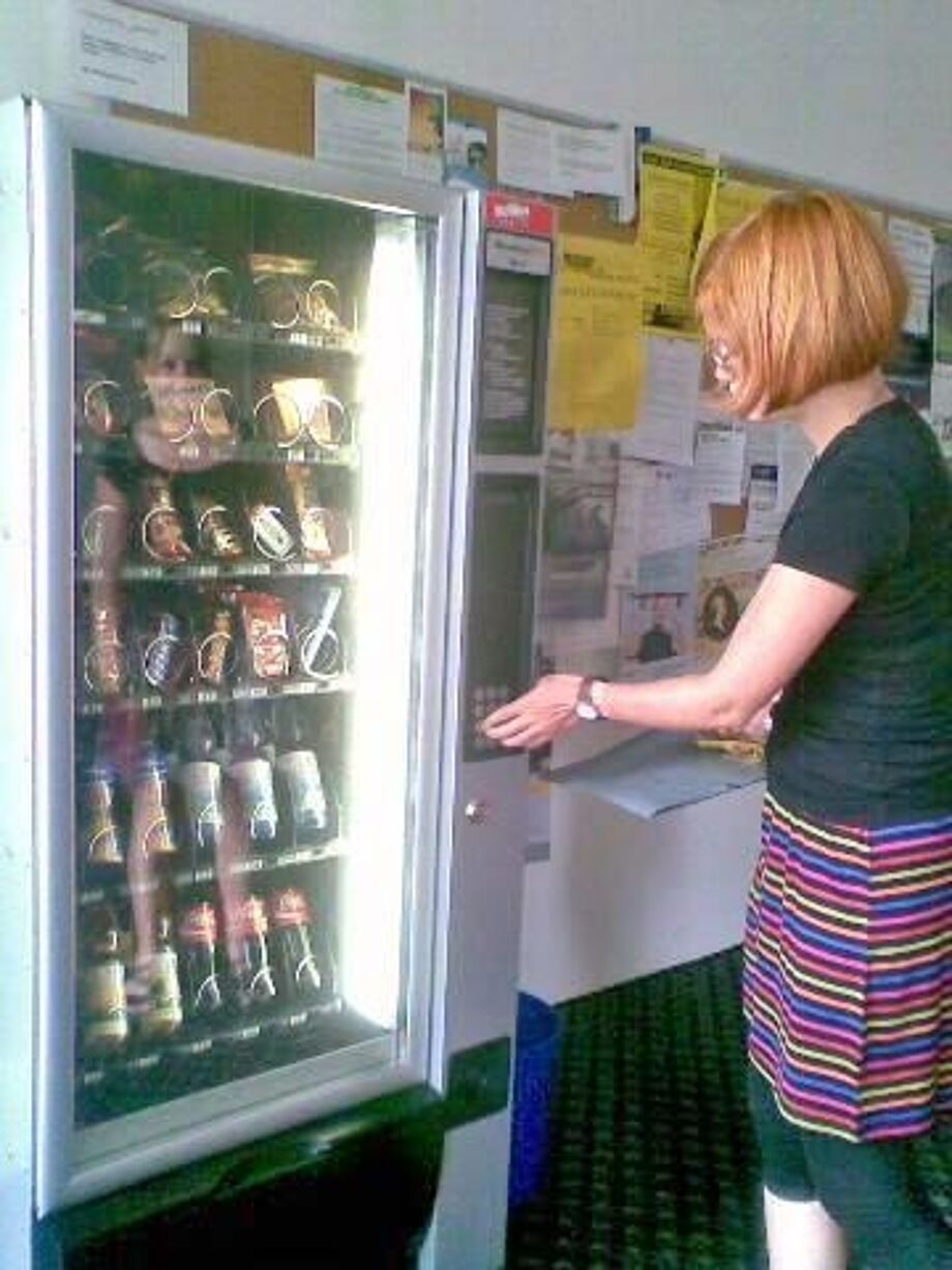 Person vor einem Verkaufsautomat